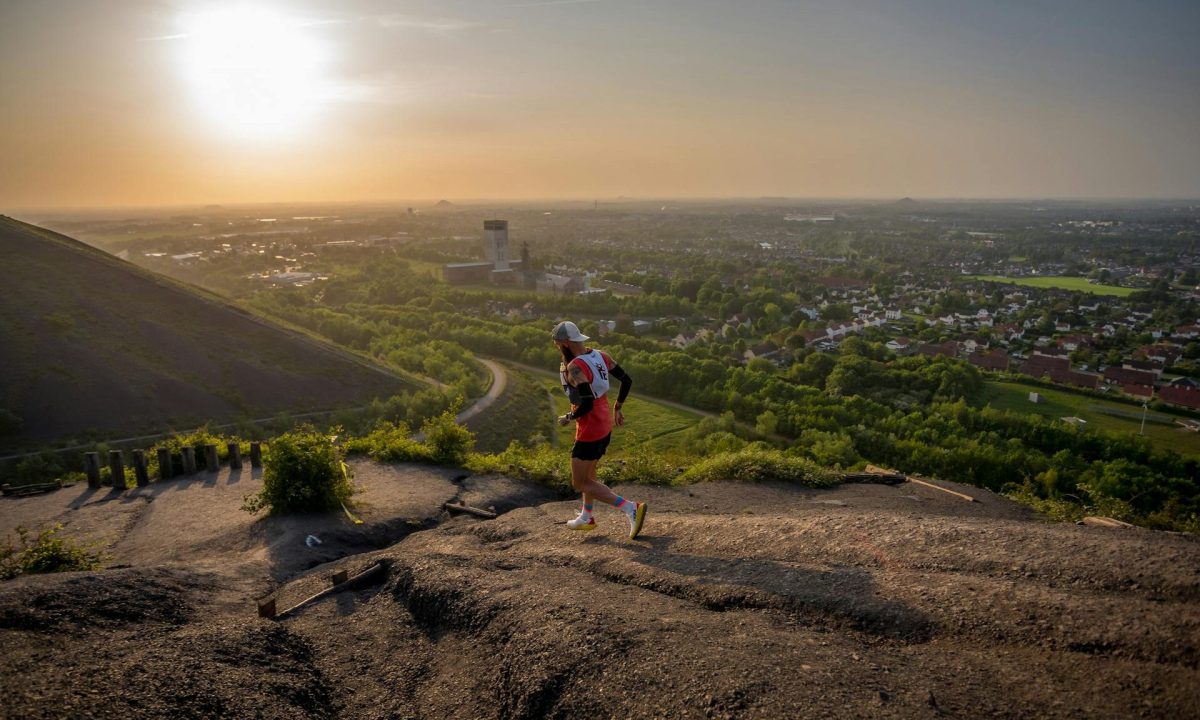man running on hill outside runner