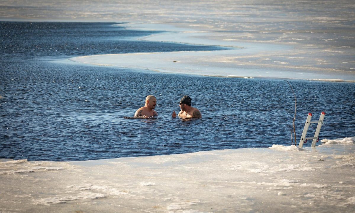 two men in icy lake ice bath swim