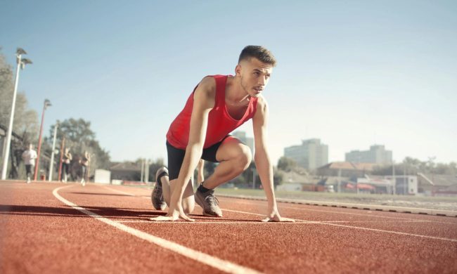 Man getting ready to run on running track