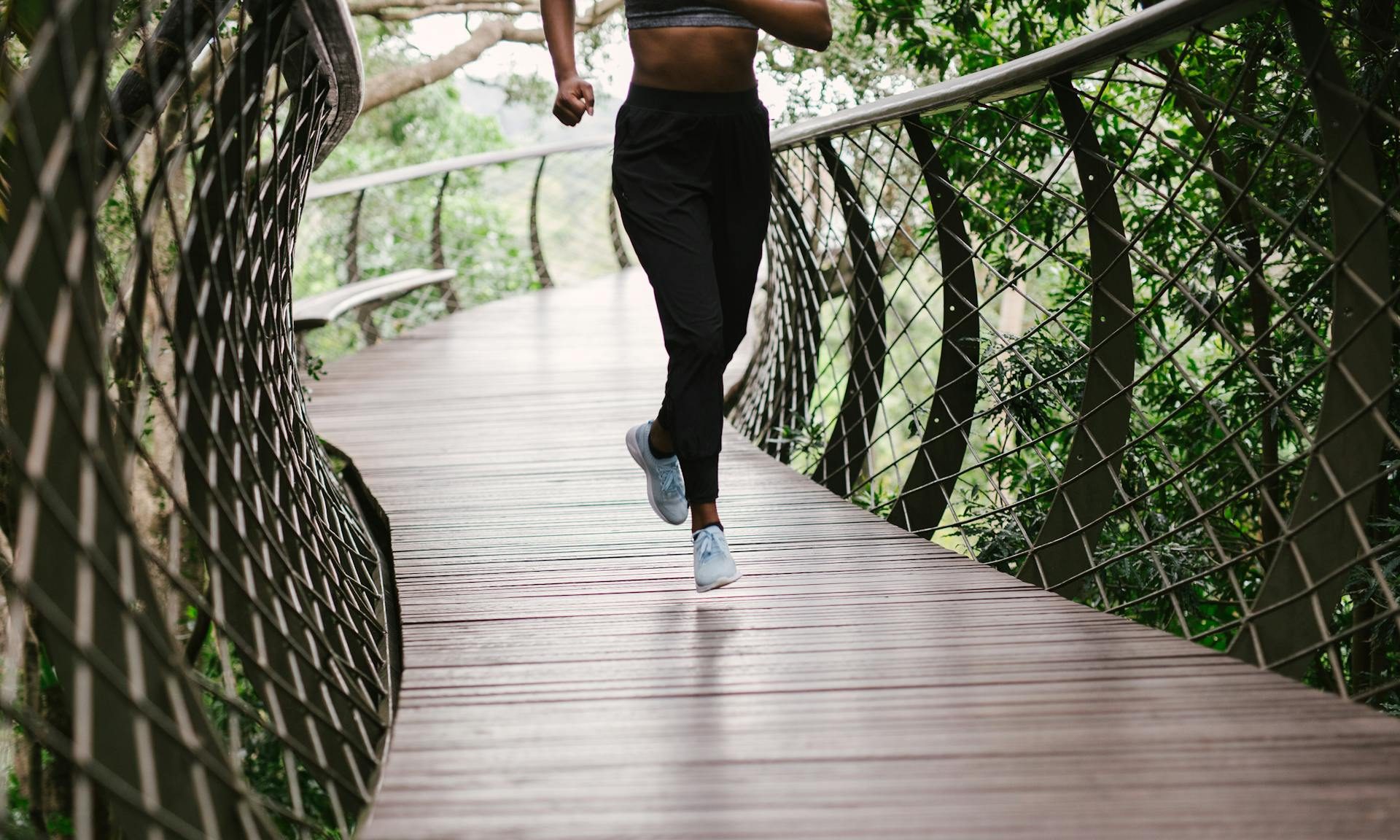 woman running through winding path