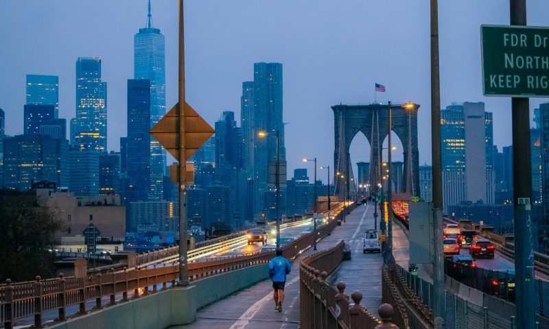 man running at sunset in the evening in the city jogging