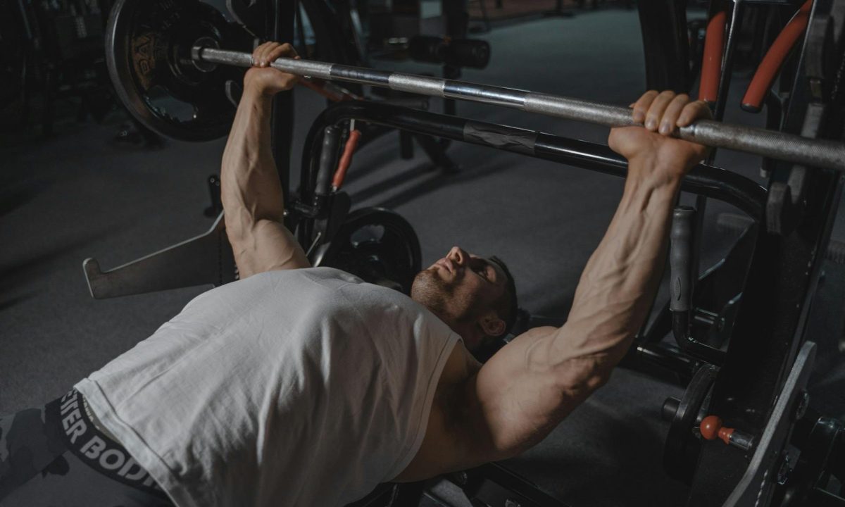man doing bench press in the gym