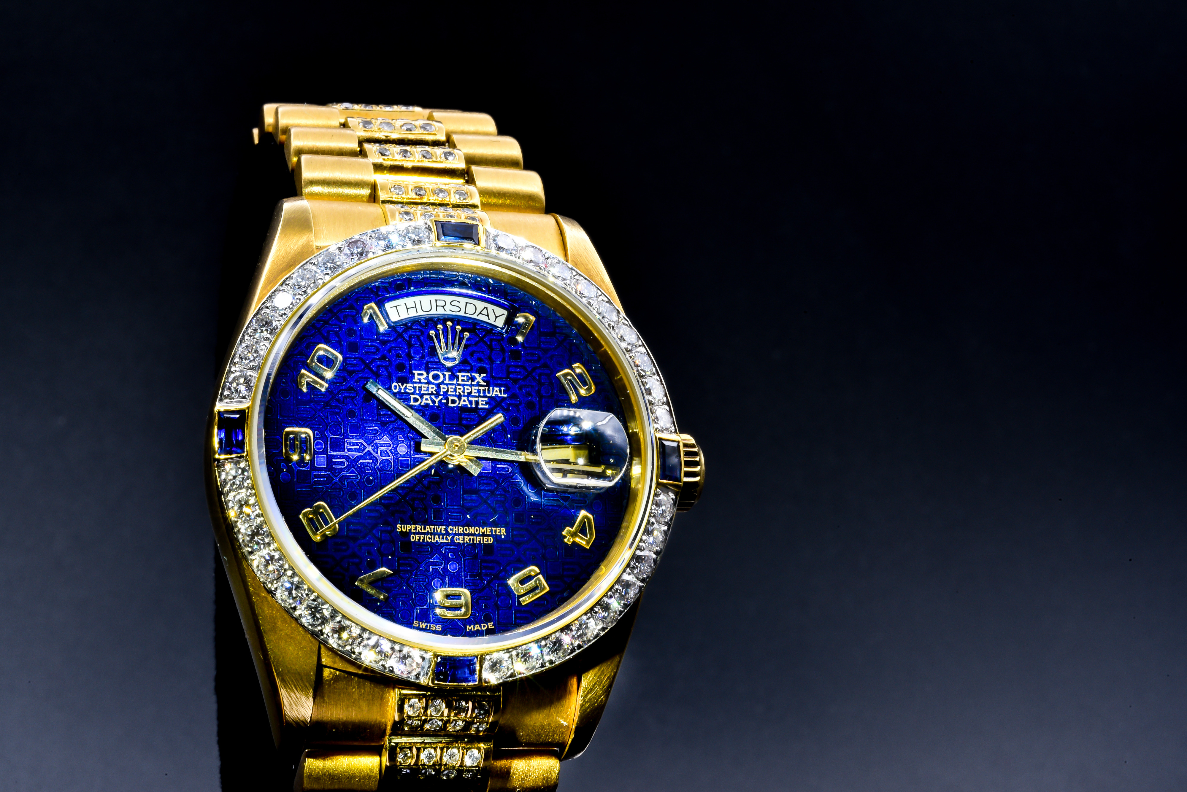 Vintage gold Rolex Day Date with diamond and sapphire bezel