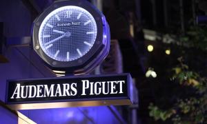 Close up Audemars Piguet store sign at night.