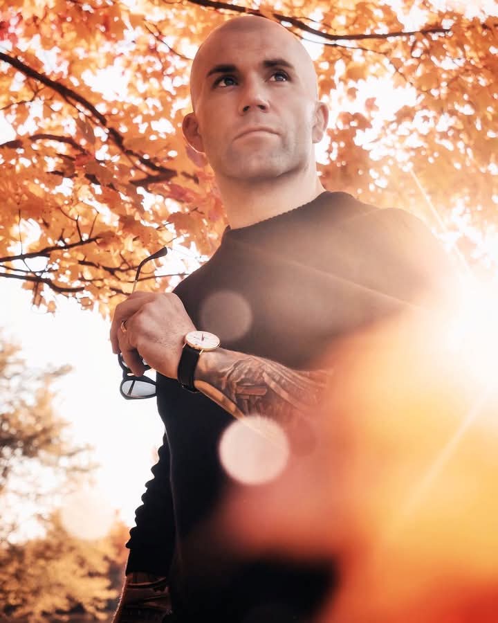 Man in the sunset by a tree wearing a watch