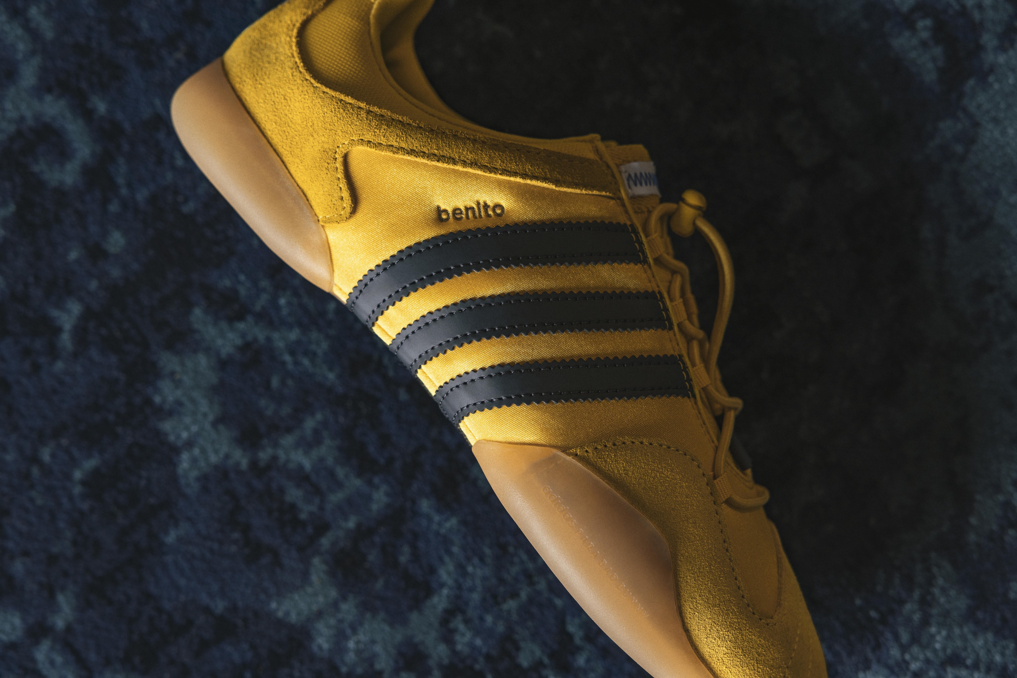 side view of adidas bad bunny sneaker on blue carpet