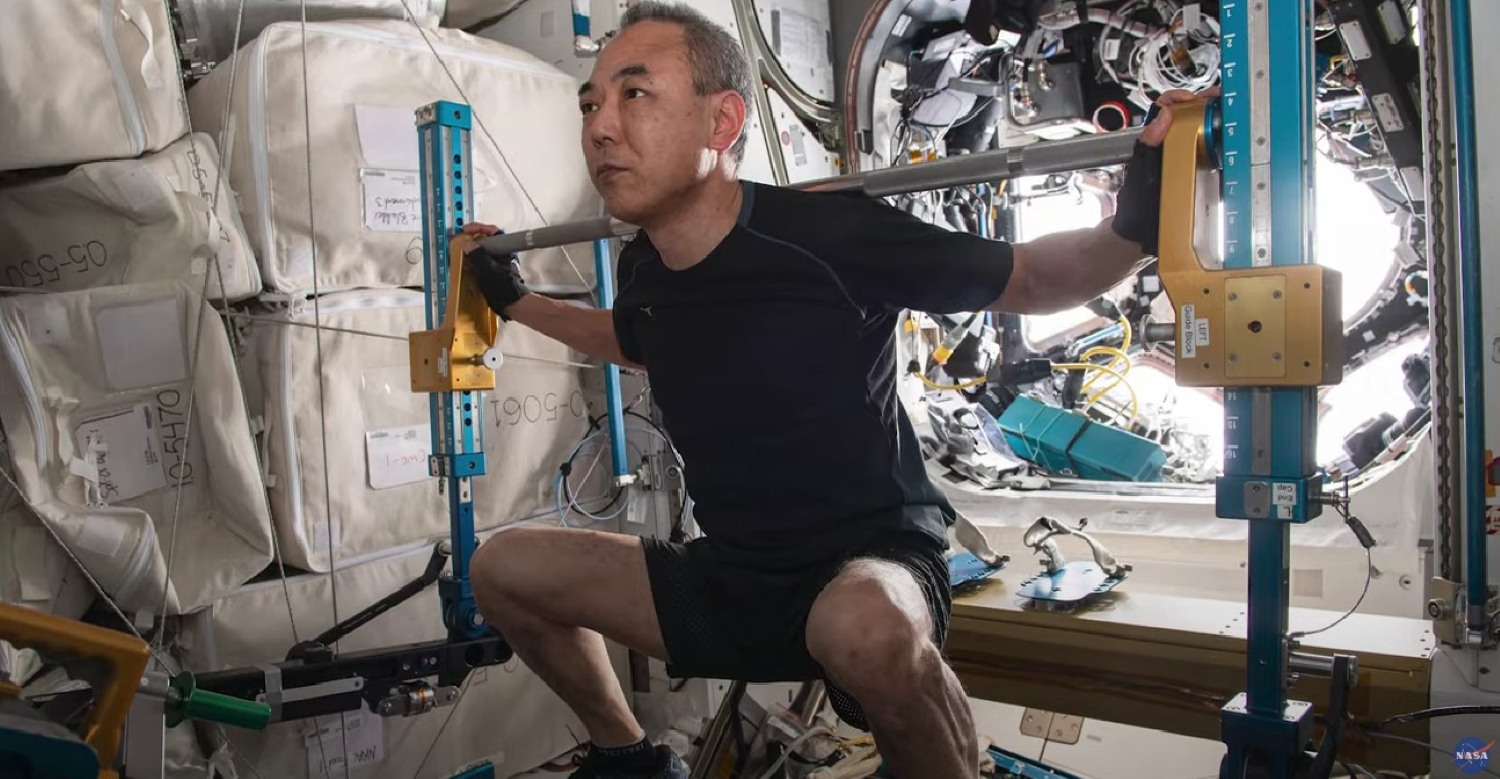 Astronaut squatting in spacecraft NASA YouTube