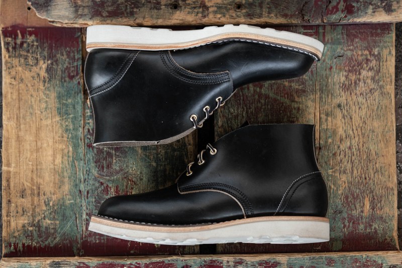black chukka boots on wood table