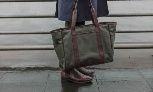 The Ghurka x David Coggins Field Tote in olive twill with brown leather straps and trim.