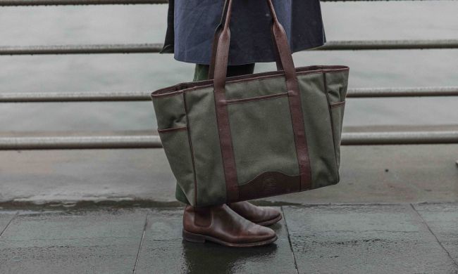 The Ghurka x David Coggins Field Tote in olive twill with brown leather straps and trim.