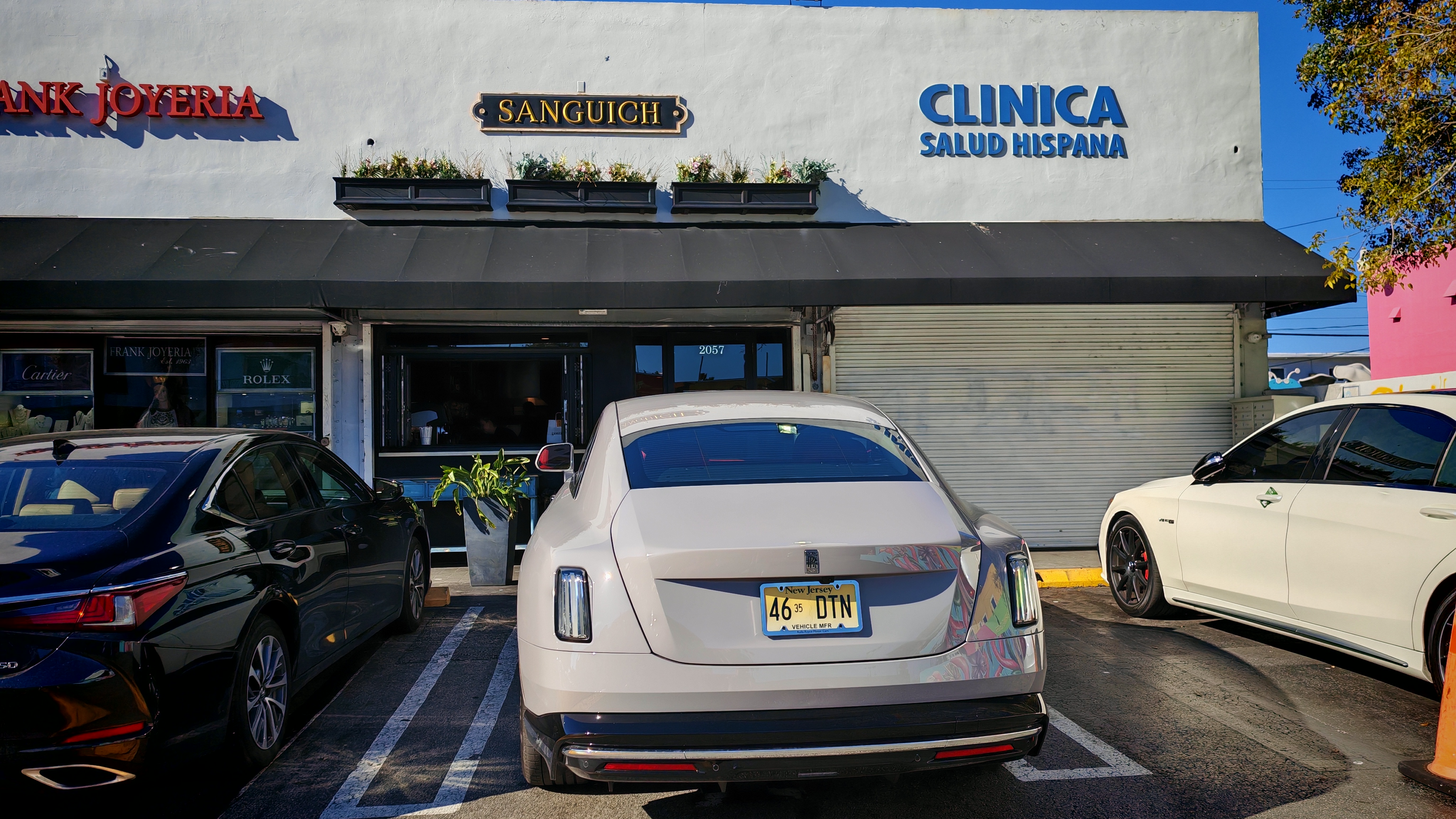 Rolls-Royce Spectre parked in front of Sanguich Miami