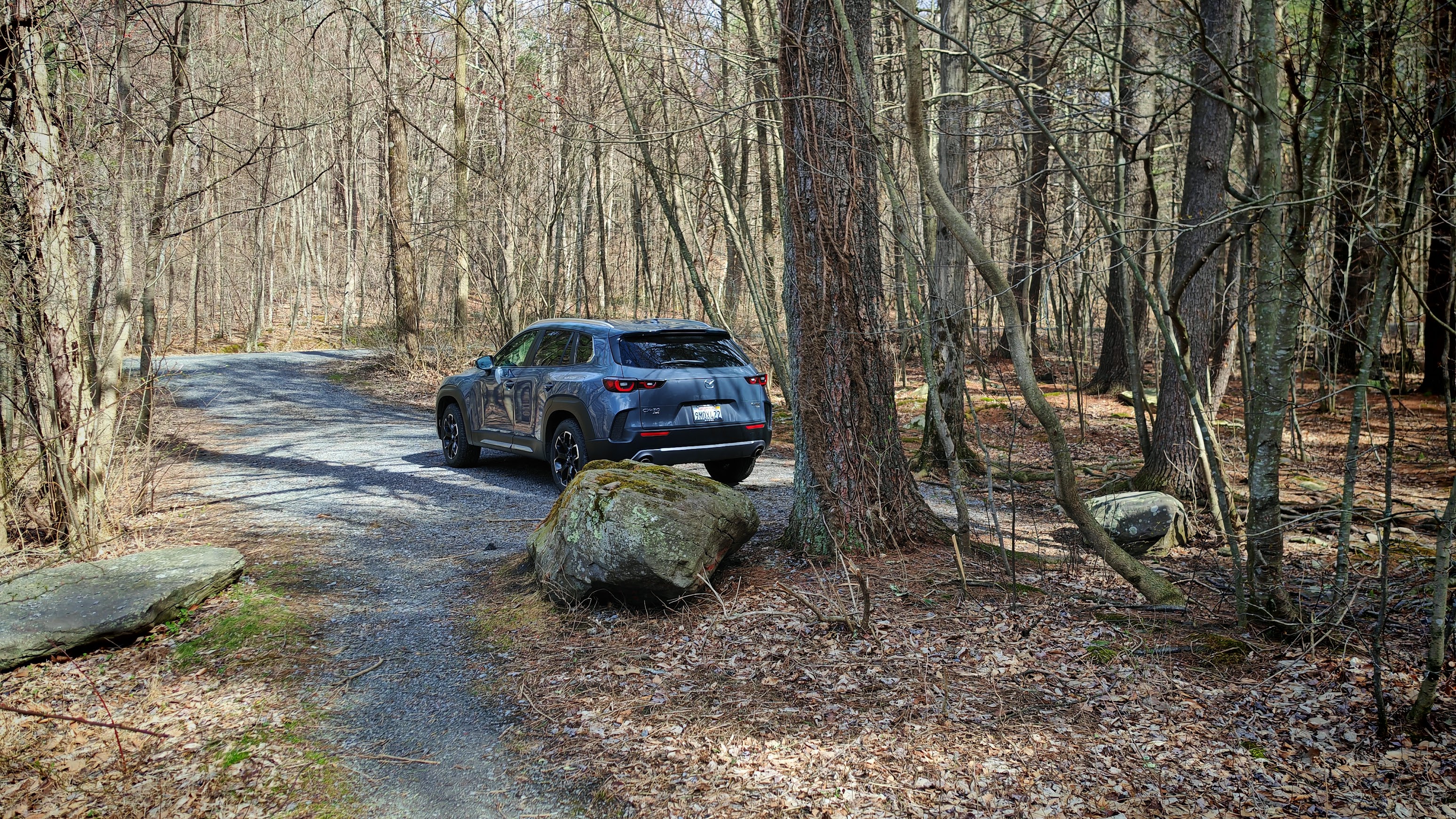 A Mazda CX-50 Meridian parked at a campsite