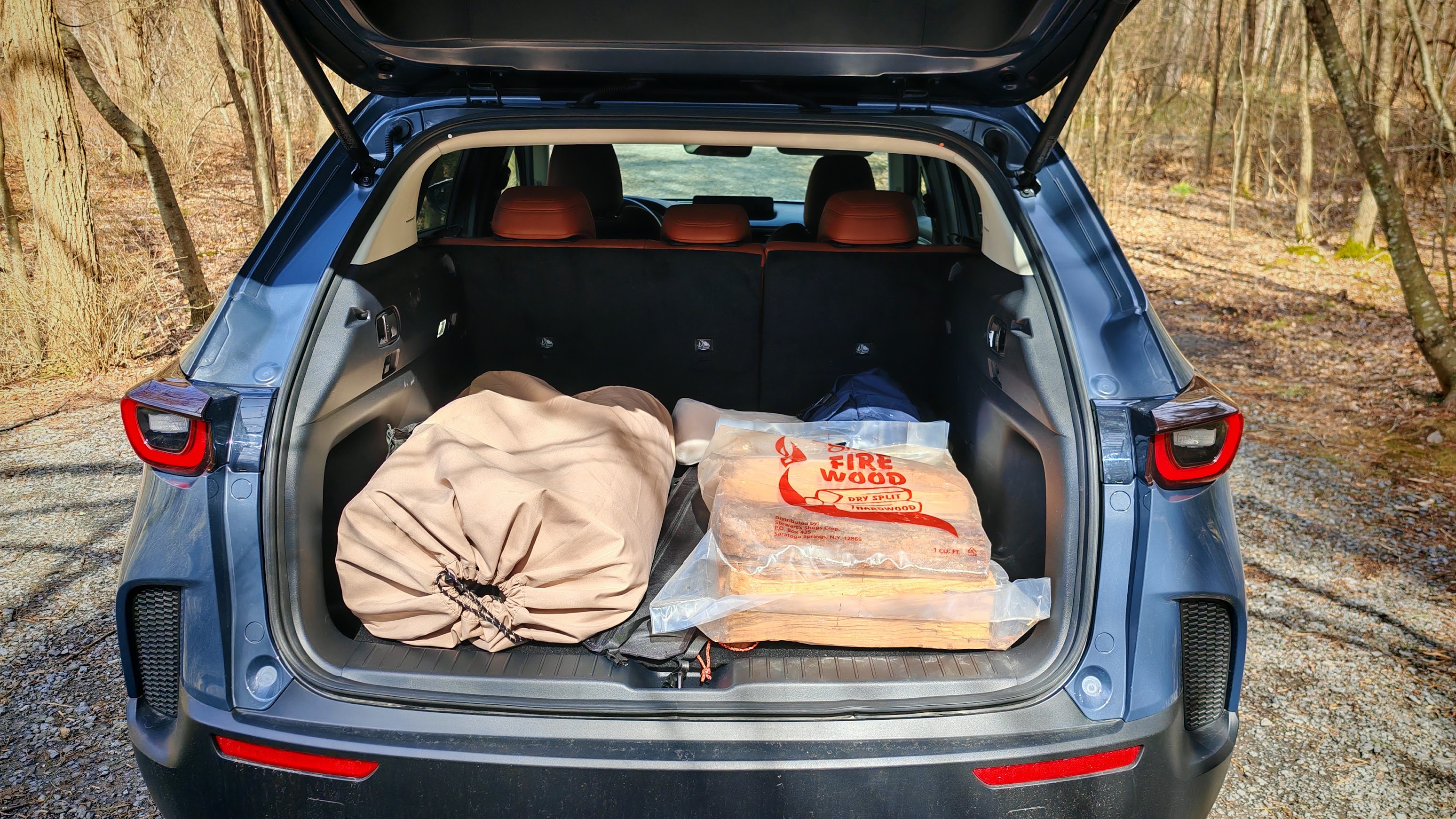 The trunk of a CX-50 with camping supplies inside