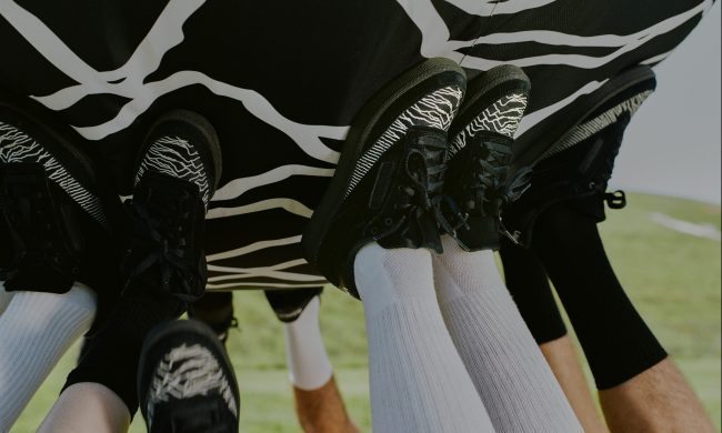 reebok sneakers holding up ball with waveform artwork