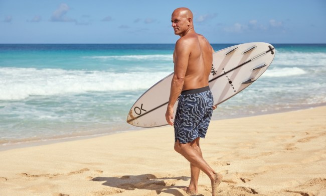 Kelly Slater Outerknown Apex EvolutionTrunk with surfboard