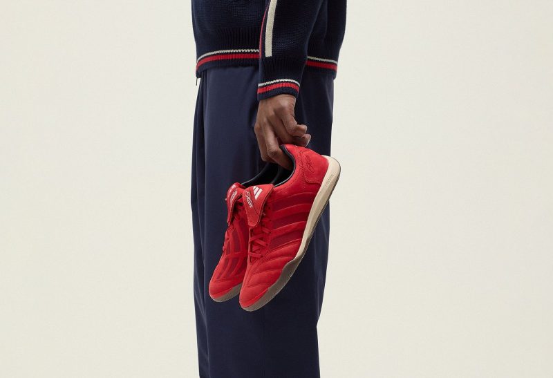 man holding red sneaker