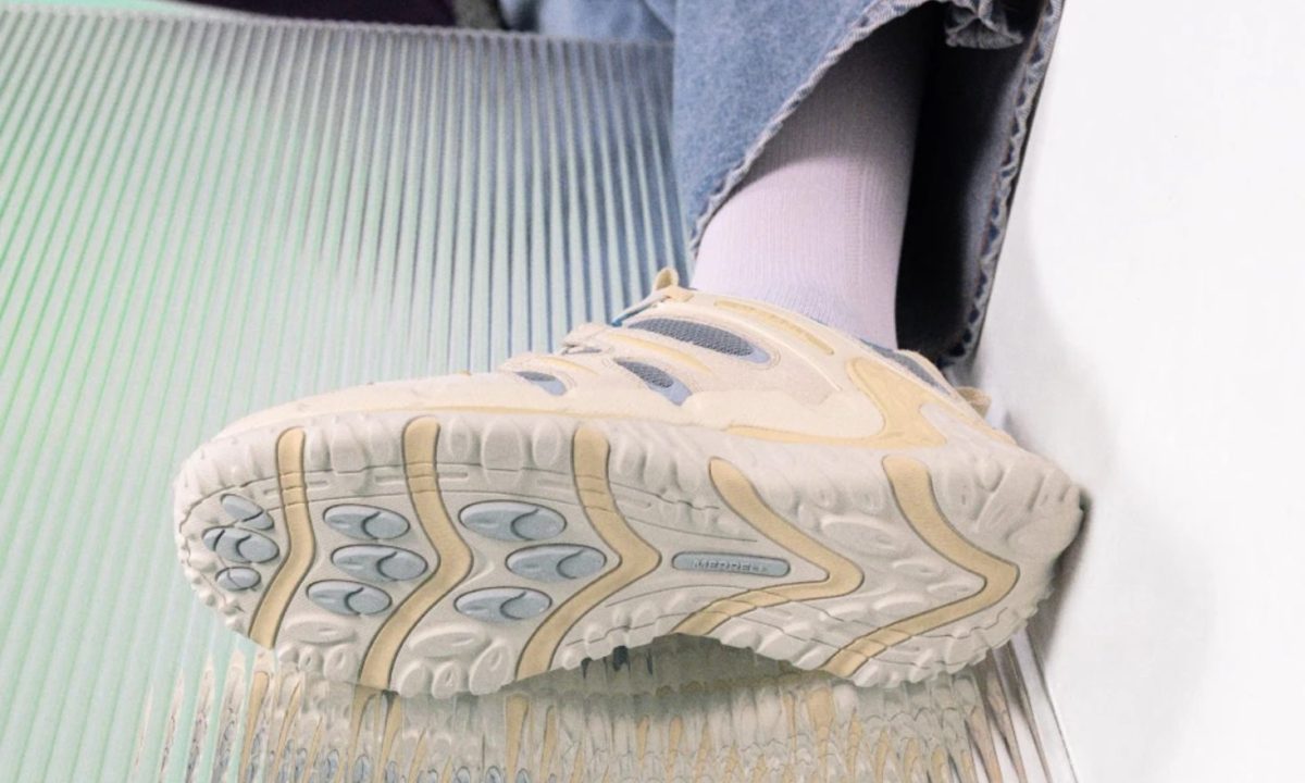 model laying with white sneaker