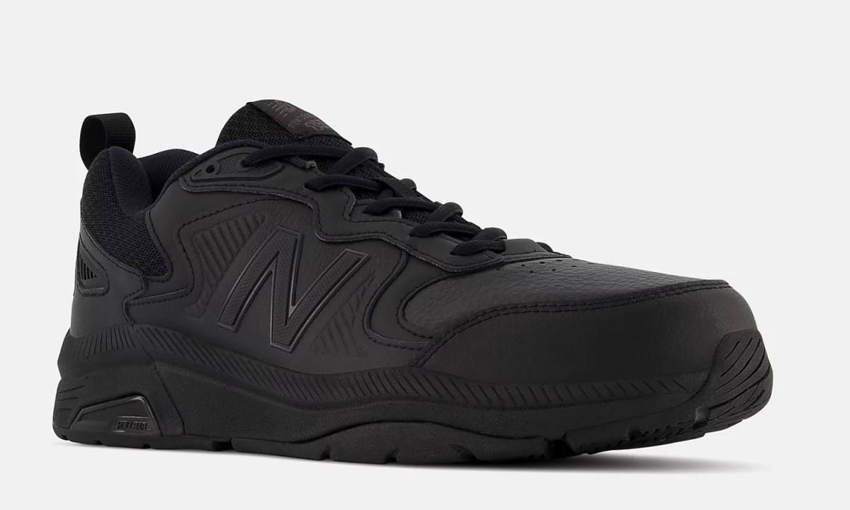 The New Balance MX857v3 Slip Resistant training shoes on a gray background.