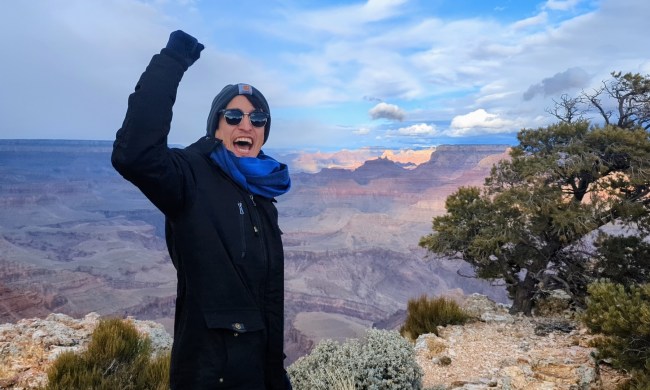 A man happily standing at the grand canyon basin
