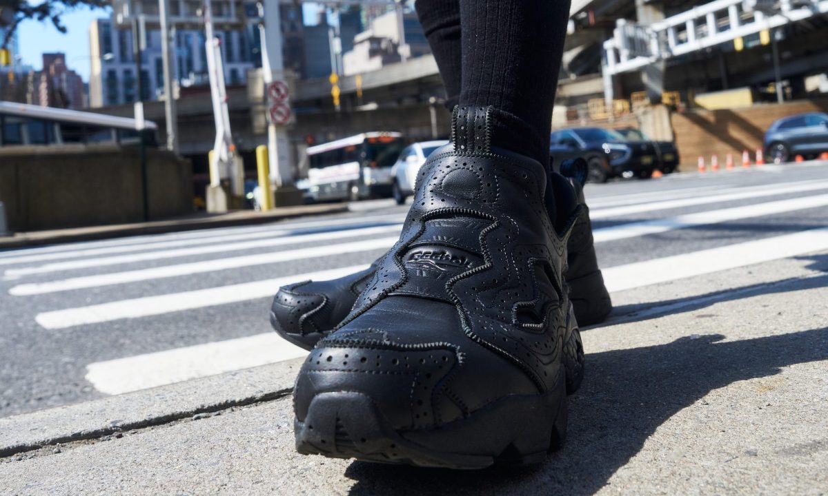 model wearing reebok sneaker on street