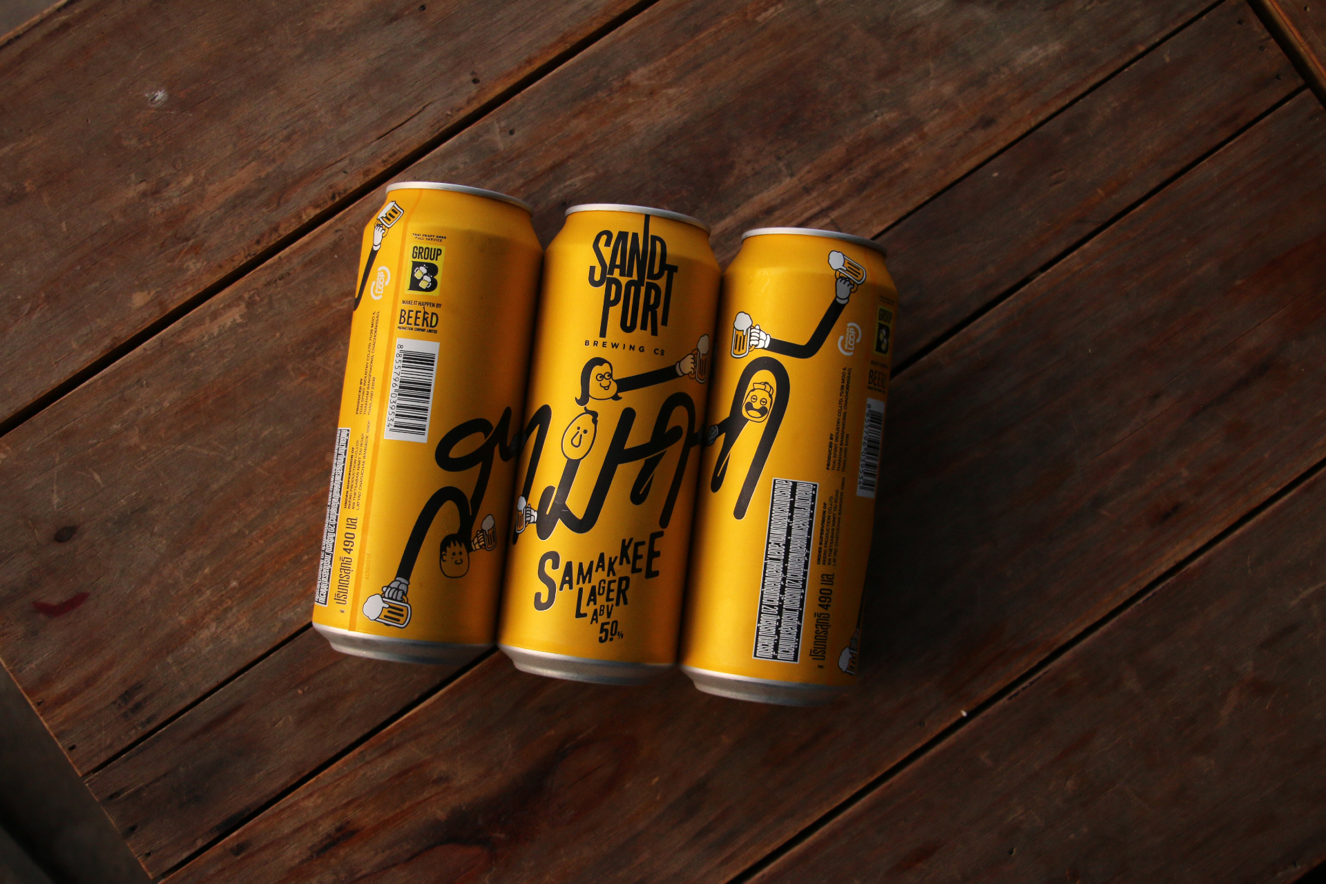 Three cans of yellow Thai beer