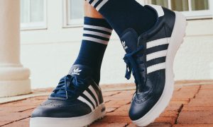 person wearing navy adidas golf shoes