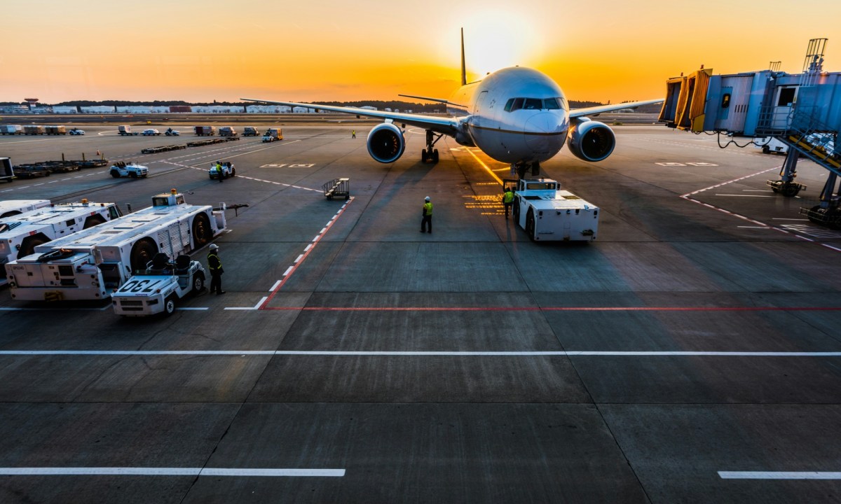 Airplane at gate sunrise