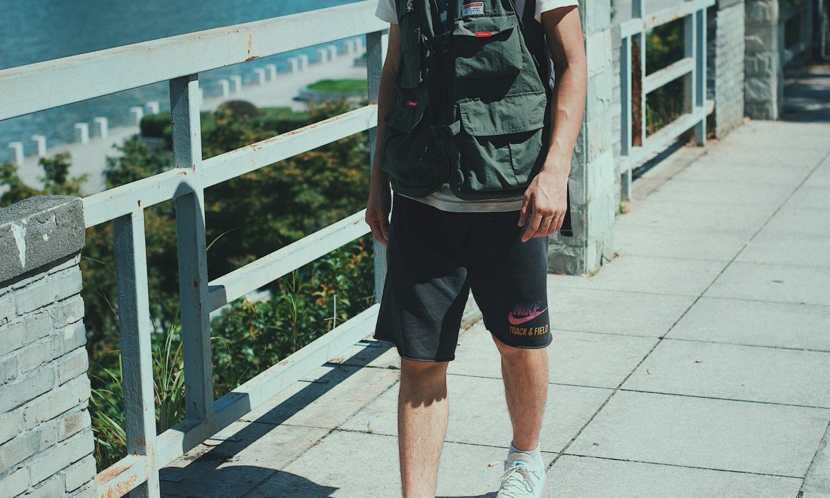 man with vest, shorts, and sneakers on vacation