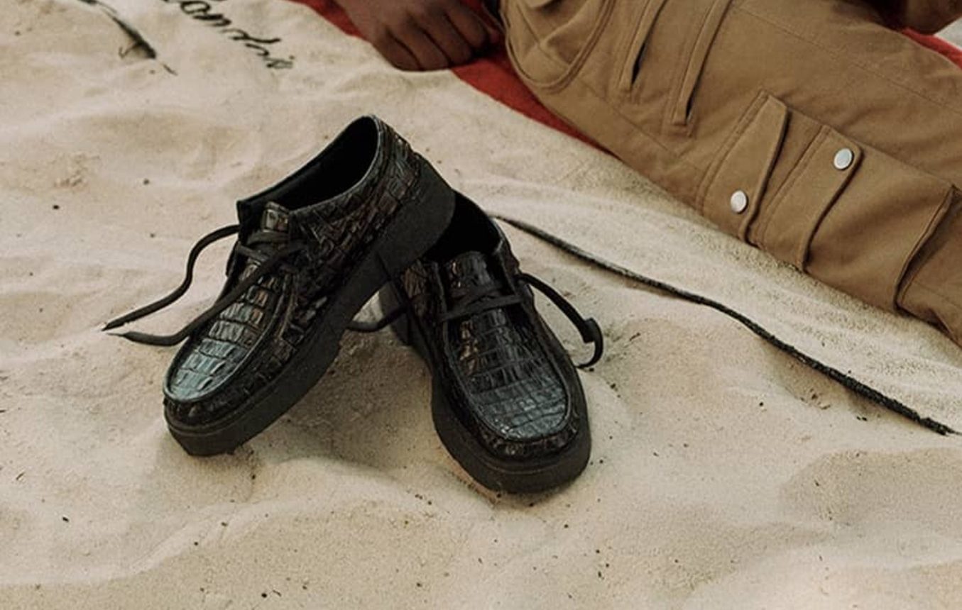 black croc shoes on sand