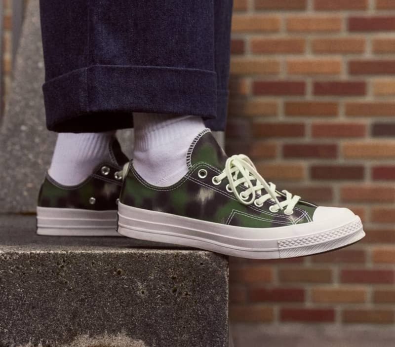 man wearing green/black converse kenzo sneaker