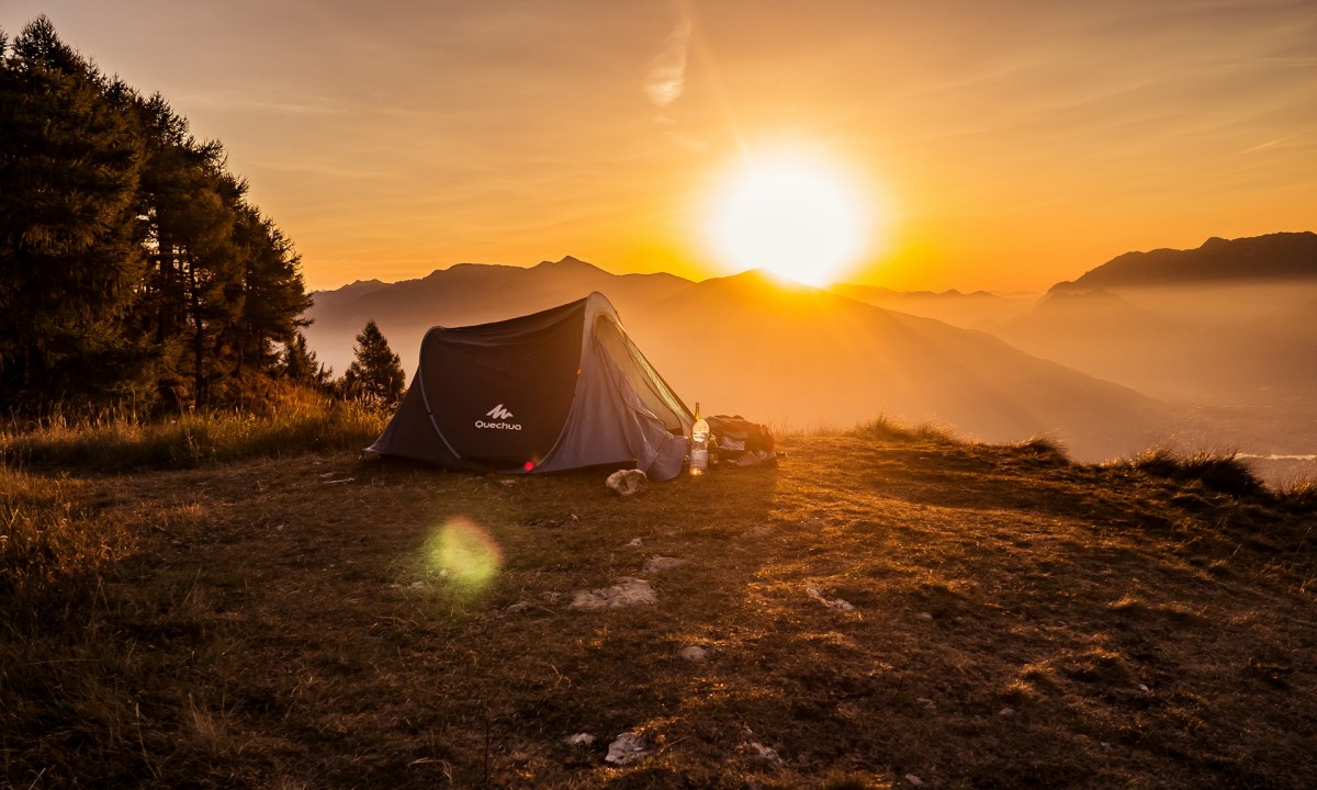 Camping with a view of the sunset over mountains