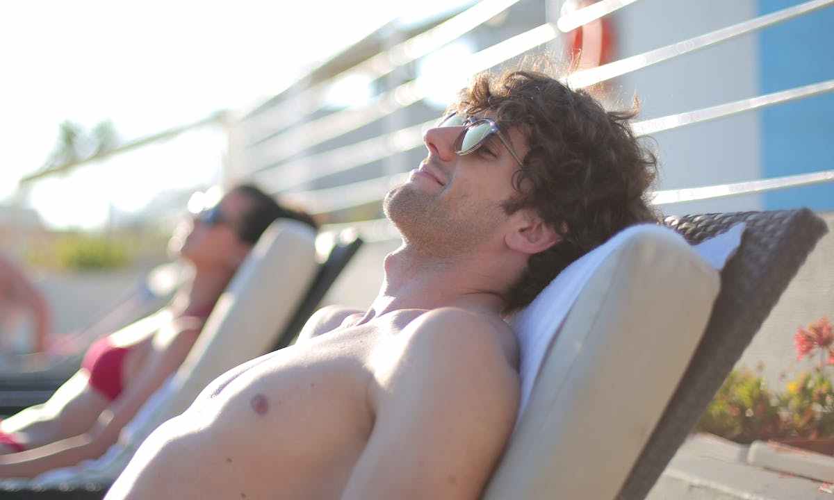 a man sitting in a beach chair at a resort