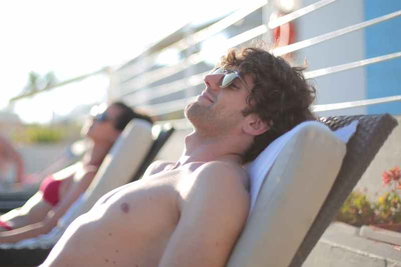 a man sitting in a beach chair at a resort