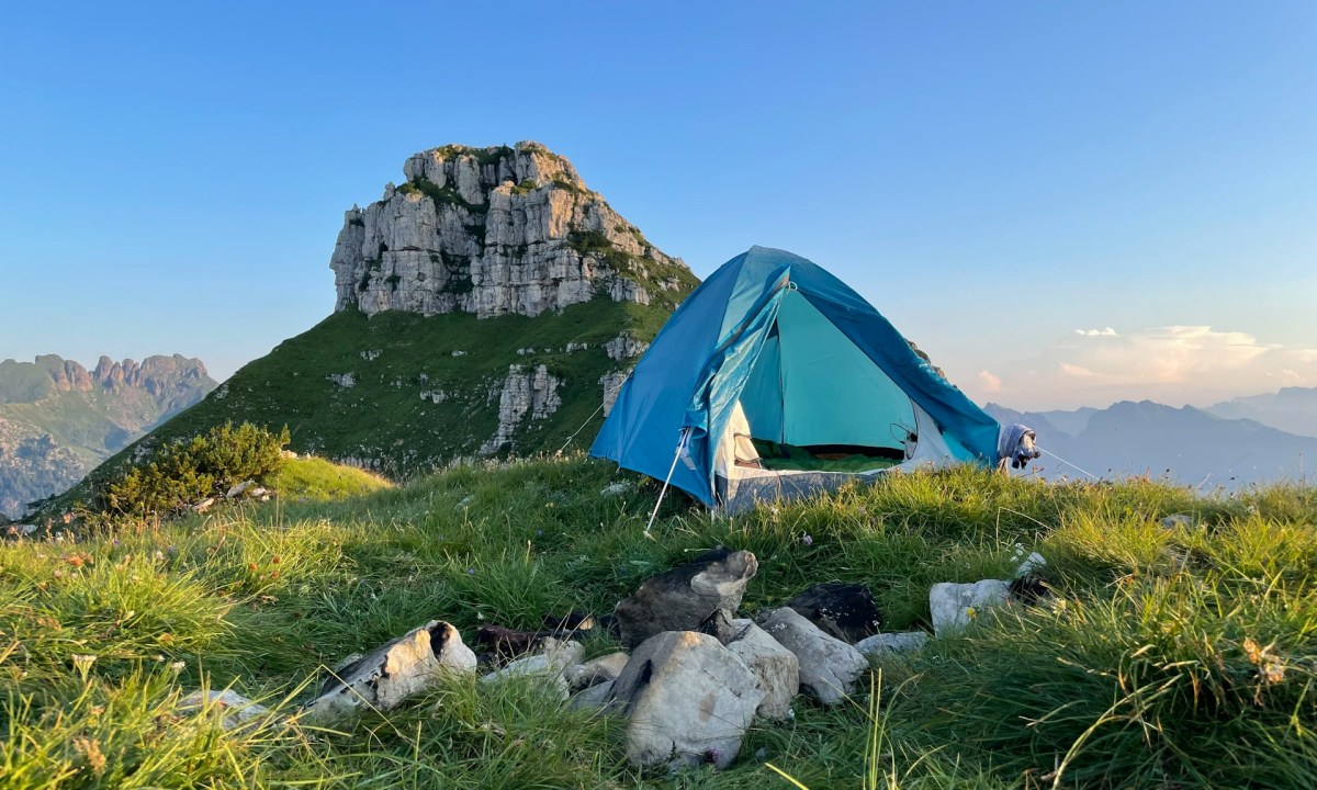 Tent pitched in front of a mountain in Belluno, Italy