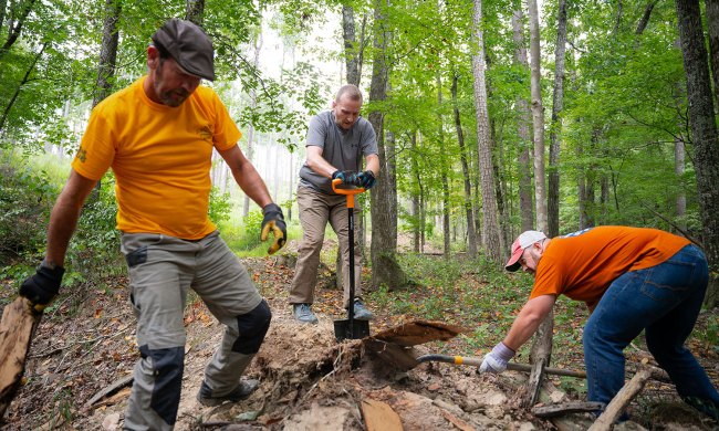 Three men clearing a trail with the onX/Toyota Trail Revival Project.
