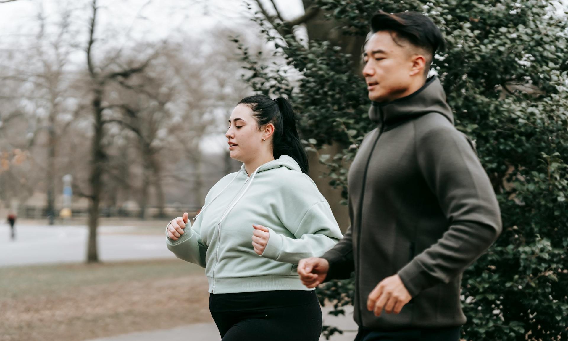 man and woman running outside