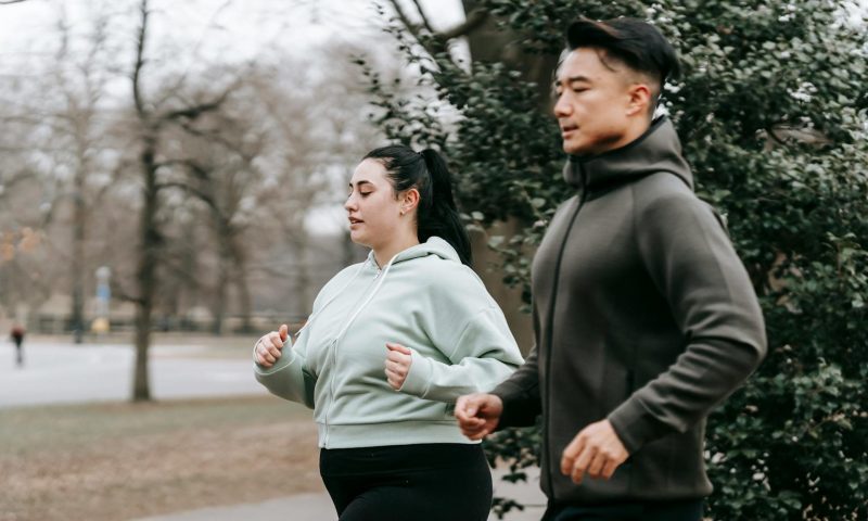 man and woman running outside
