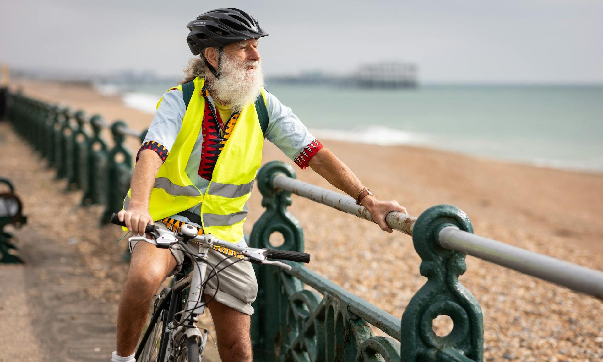 man riding bicycle outdoors by beach