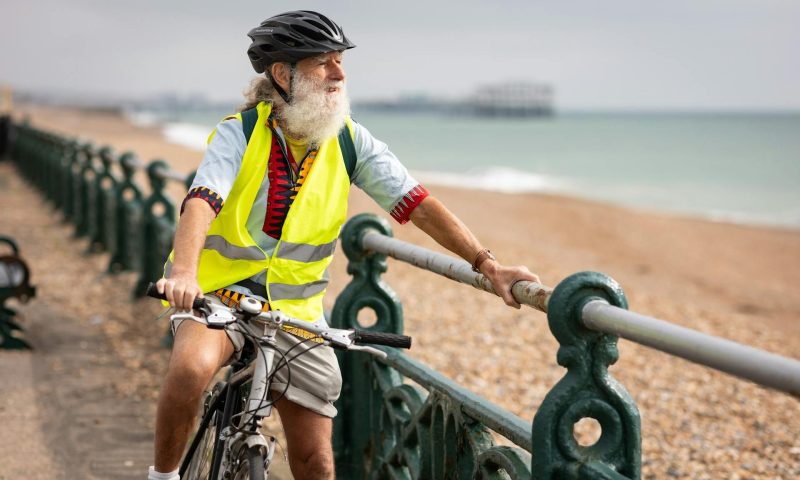 man riding bicycle outdoors by beach
