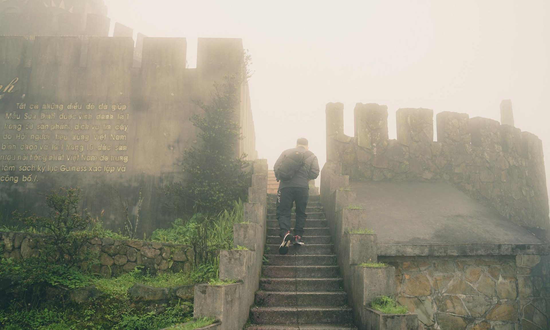 man walking up stairs castle stone