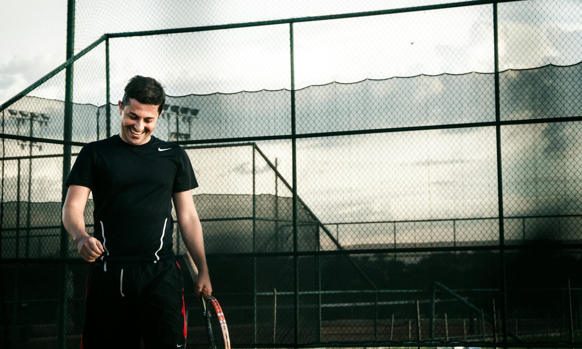 Happy man playing tennis