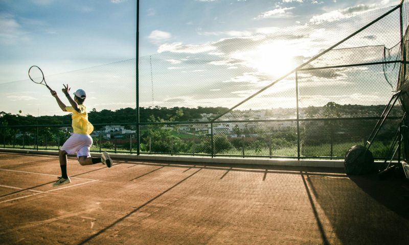 man playing tennis active