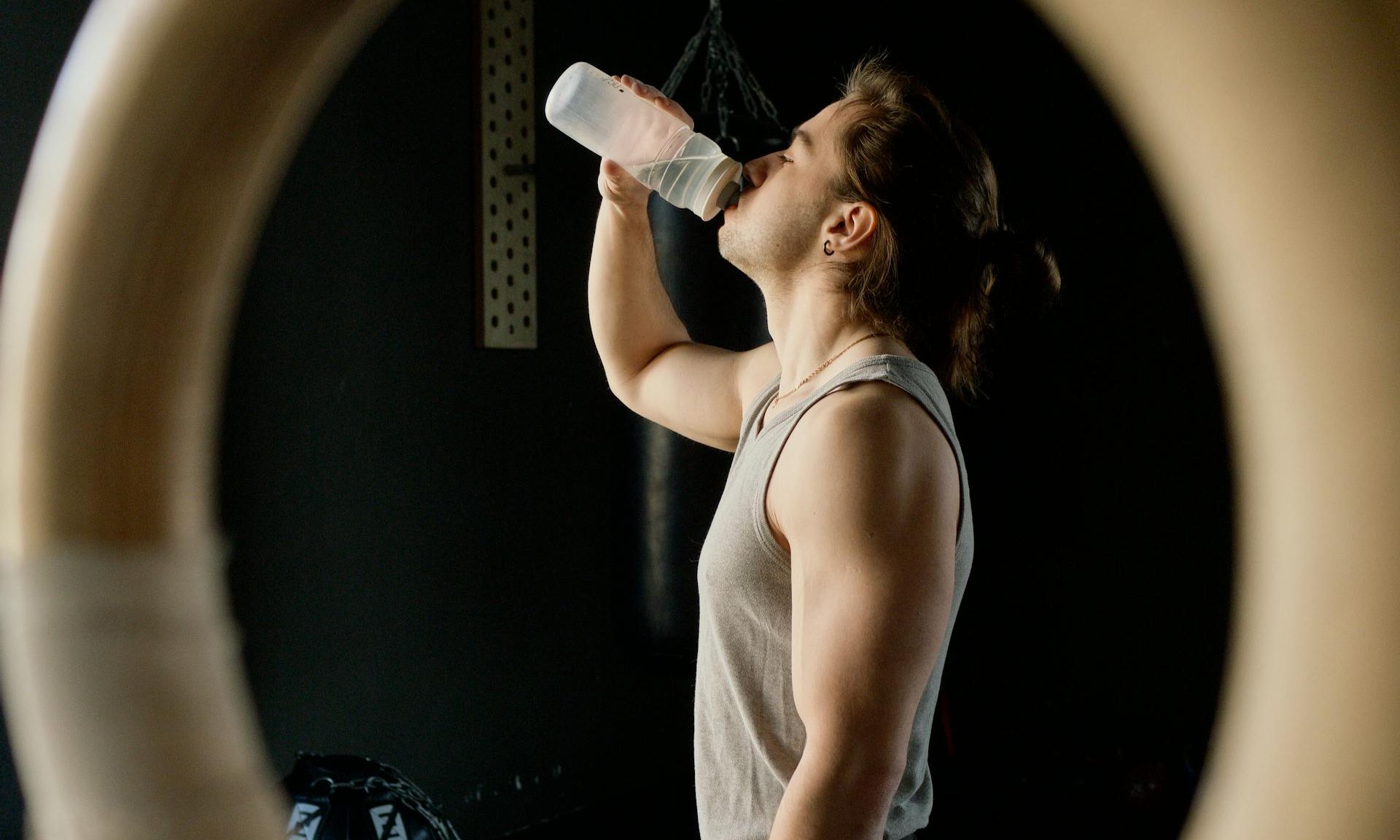 Man drinking water gymnastic ring