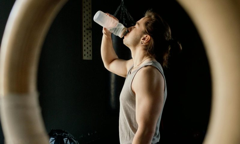 Man drinking water gymnastic ring