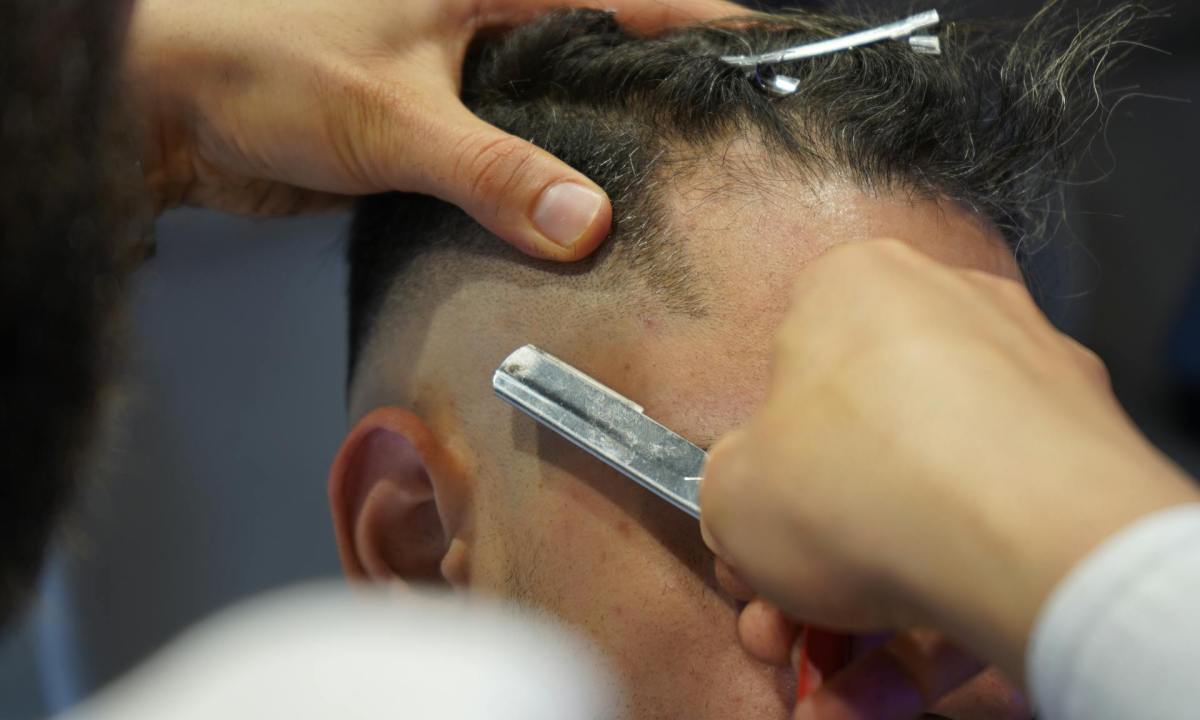 man getting a haircut razor blade