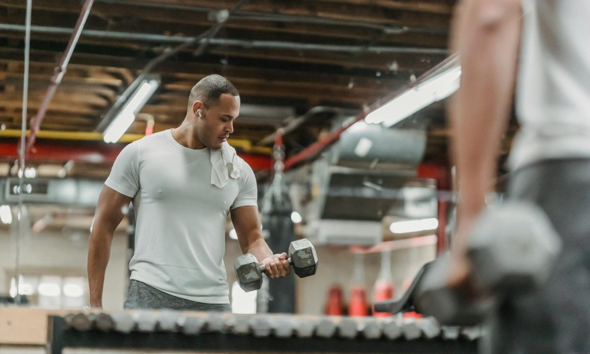 man bicep curl gym lifting weights