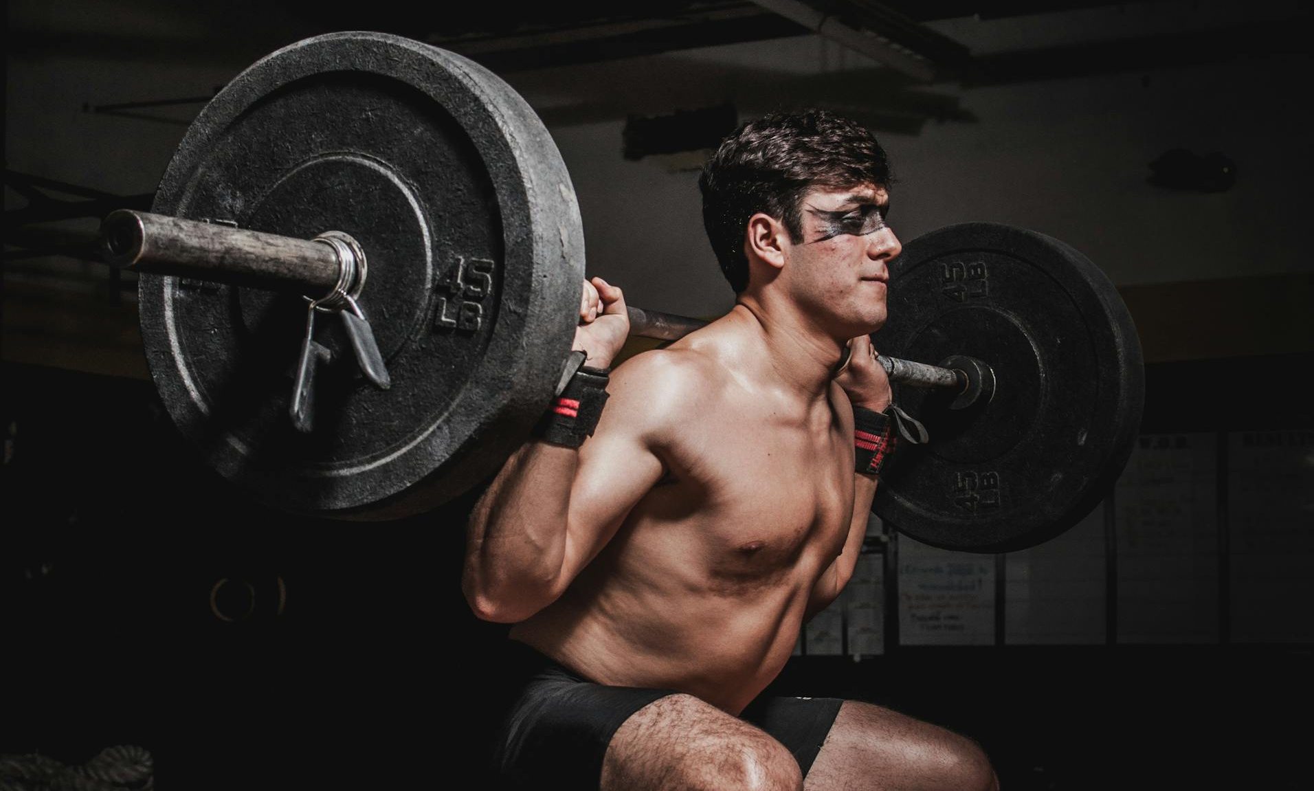 man doing barbell back squat