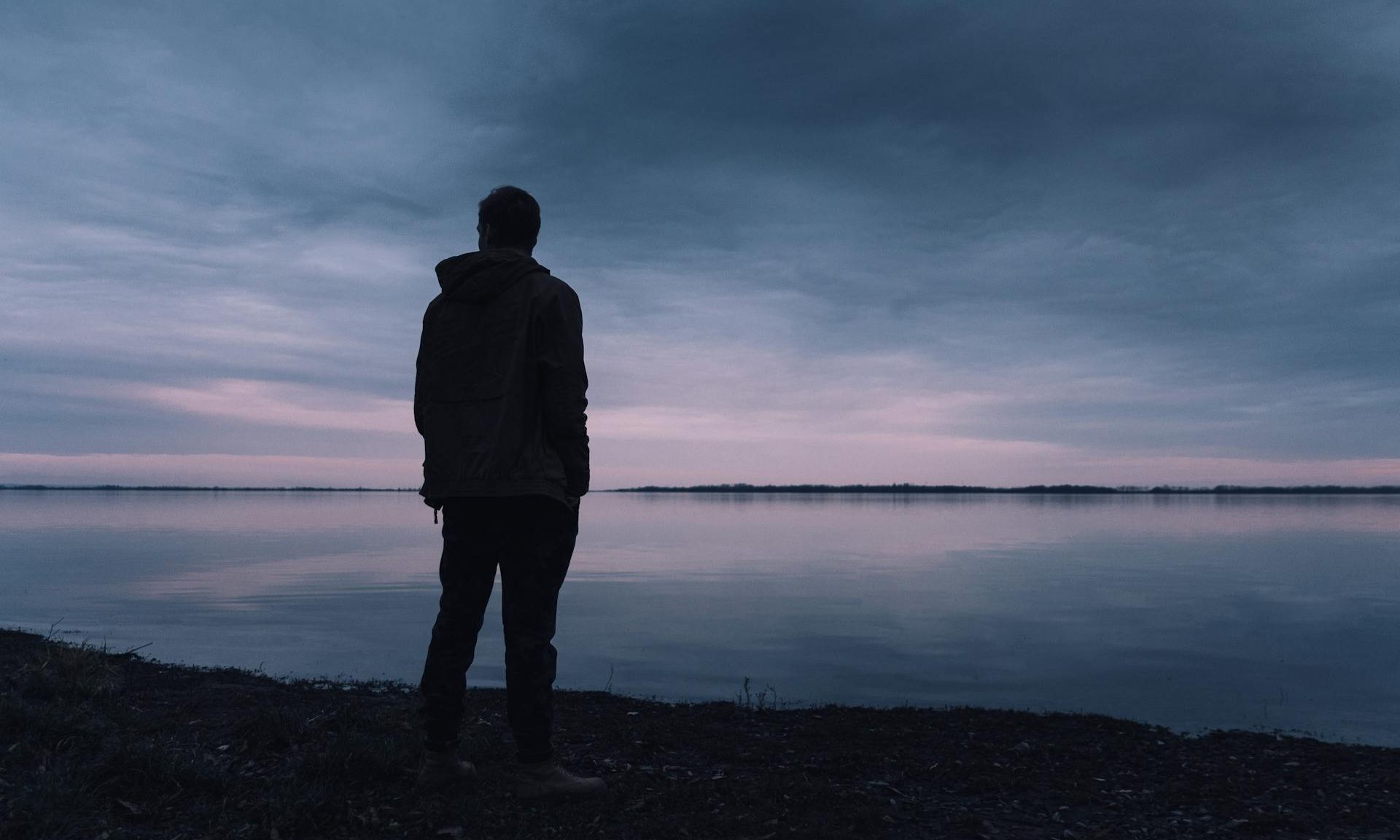 Man looking at water reflective