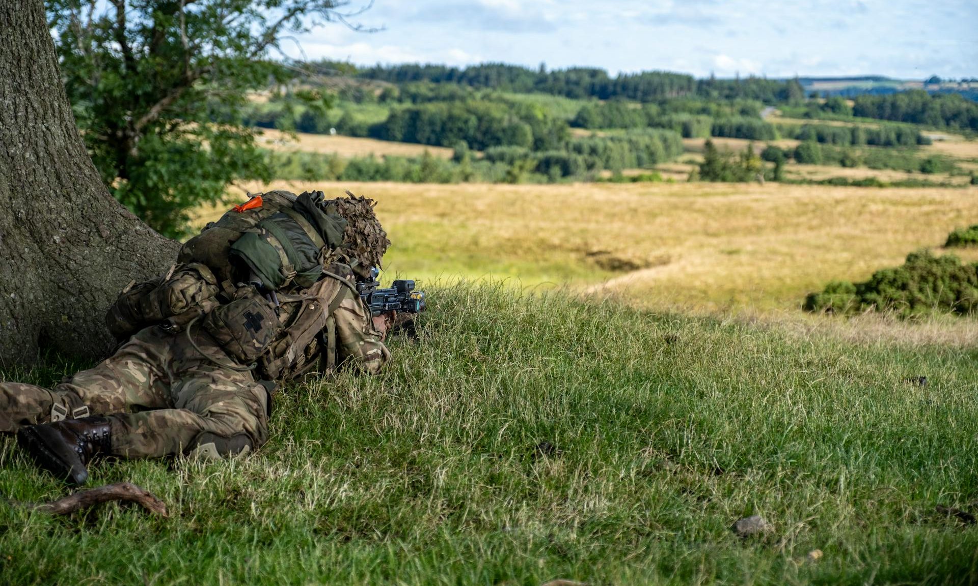 army man laying down on grass soldier