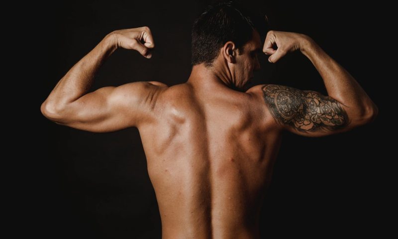 strong back muscles man flexing back